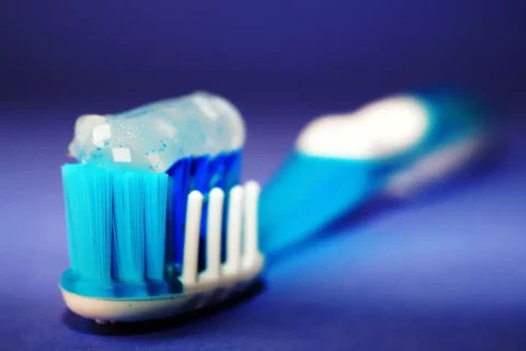 An affordable toothbrush in blue and white on a blue background, perfect for Dental Solutions in Potomac, MD.